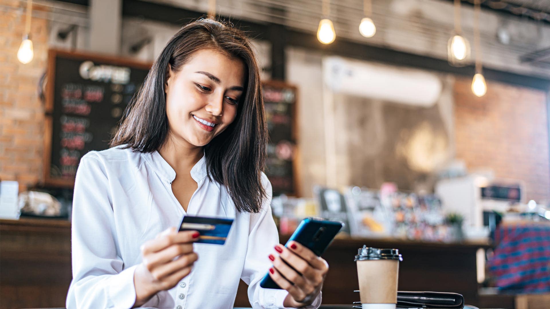 Woman paying by phone Parents can pay online via the cashless campus app on their mobile phones
