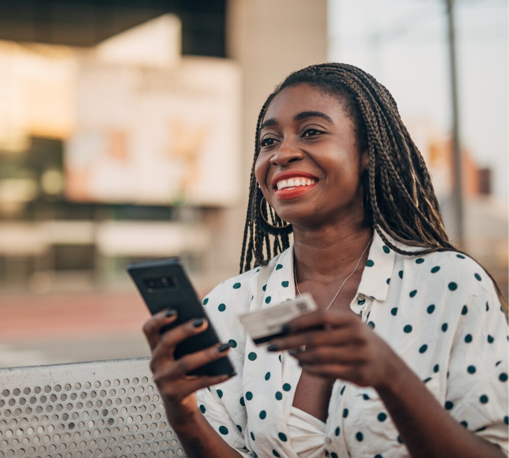 Smiling woman with phone and card Smiling woman with phone and card